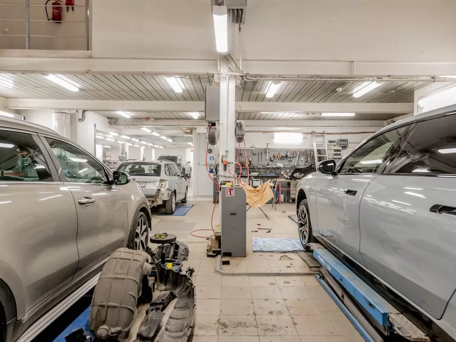 Professional auto body shop interior with vehicles undergoing collision repair